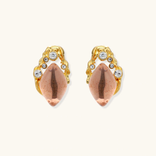 Gold-plated baroque stud earrings with coral-pink liuli stones and cubic zirconia crystals on white background.