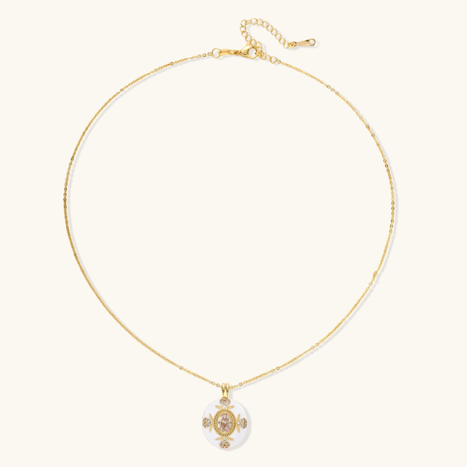 Gold-plated necklace with circular white enamel pendant featuring central zirconia stone and ornate decorative details