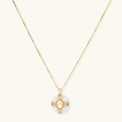 Gold-plated necklace with circular white enamel pendant featuring central zirconia stone and ornate decorative details