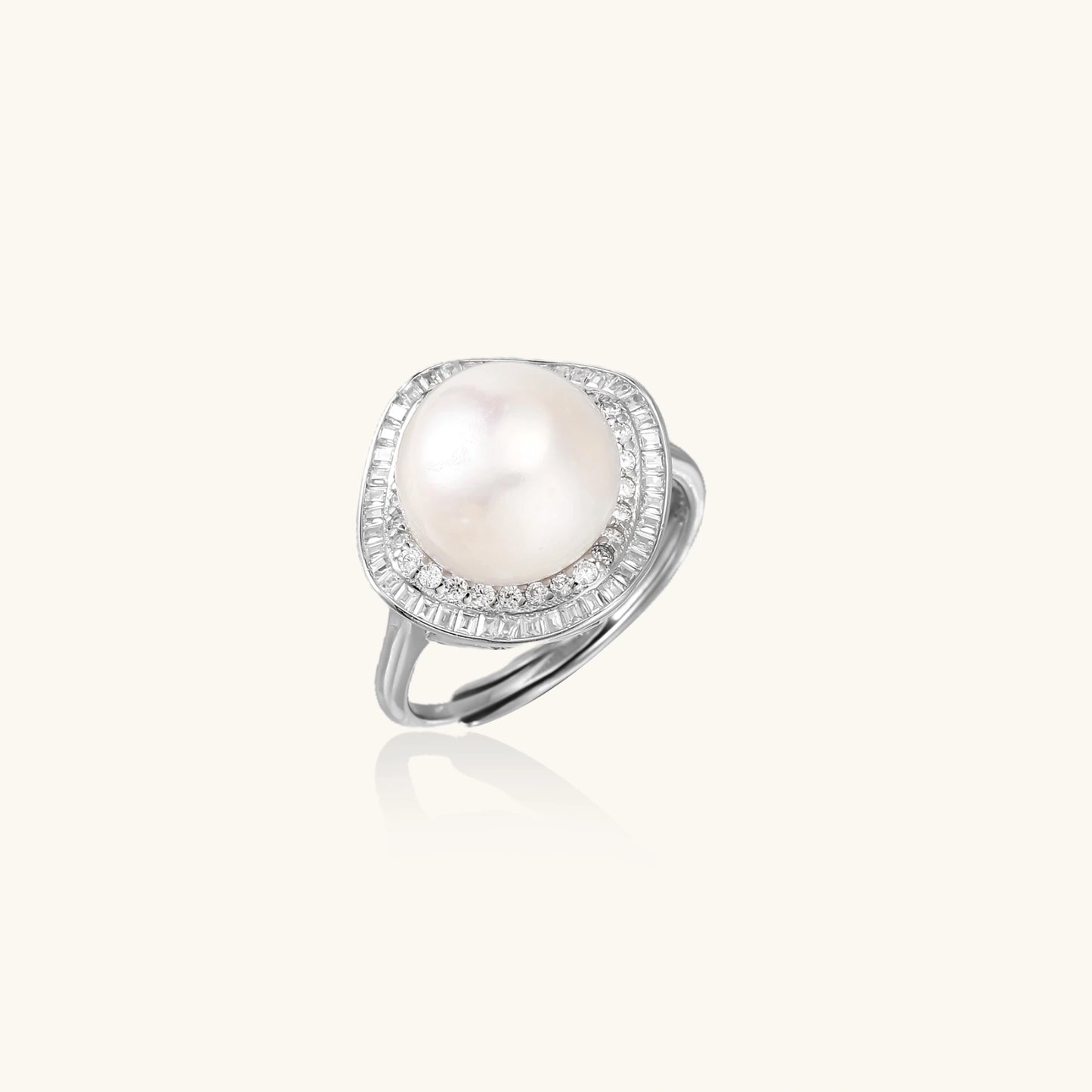 Rhodium-plated silver ring with round pearl center, double halo of baguette and round crystals forming cushion shape